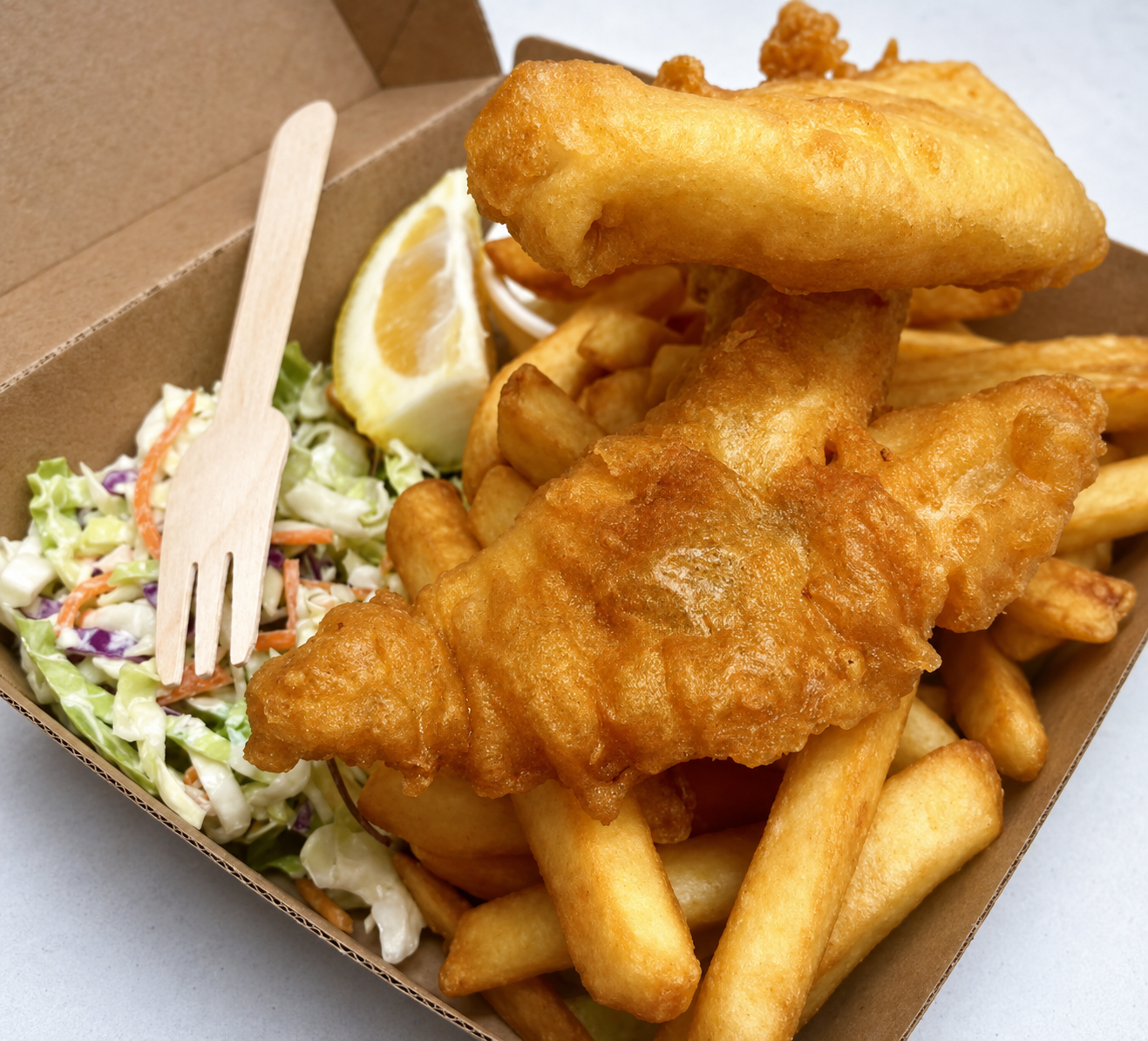 Fishbox with battered fish, chips and slaw